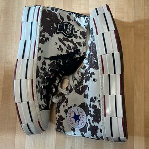 Cow print hightop/platform Converse.